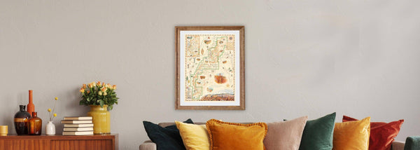 Arches and Canyonlands National Park Hand-Drawn Map framed hanging above a couch in a living room. 