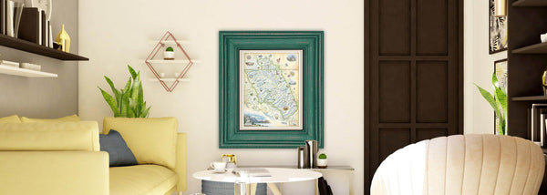 Glacier National Park hand-drawn map in a green frame hanging on a neutral wall with yellow couch. 