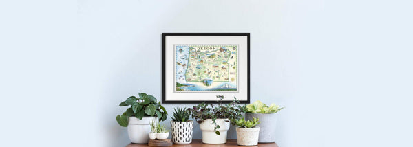 Natural tones map of Oregon with houseplants & succulents. Artist Chris Robitaille is drawing on the right.