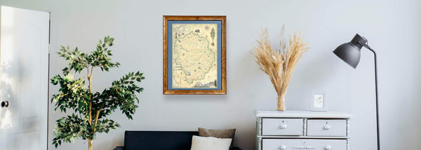 Lithographic Map Art Print features a hand-illustrated map of Yosemite National Park hung above a couch on a white wall. 