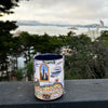 San Francisco ceramic mug sitting outside a balcony in the city.