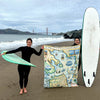 San Francisco Bay fleece blanket being hed up by two surfers. In the background is the Bay and Golden Gate Bridge.