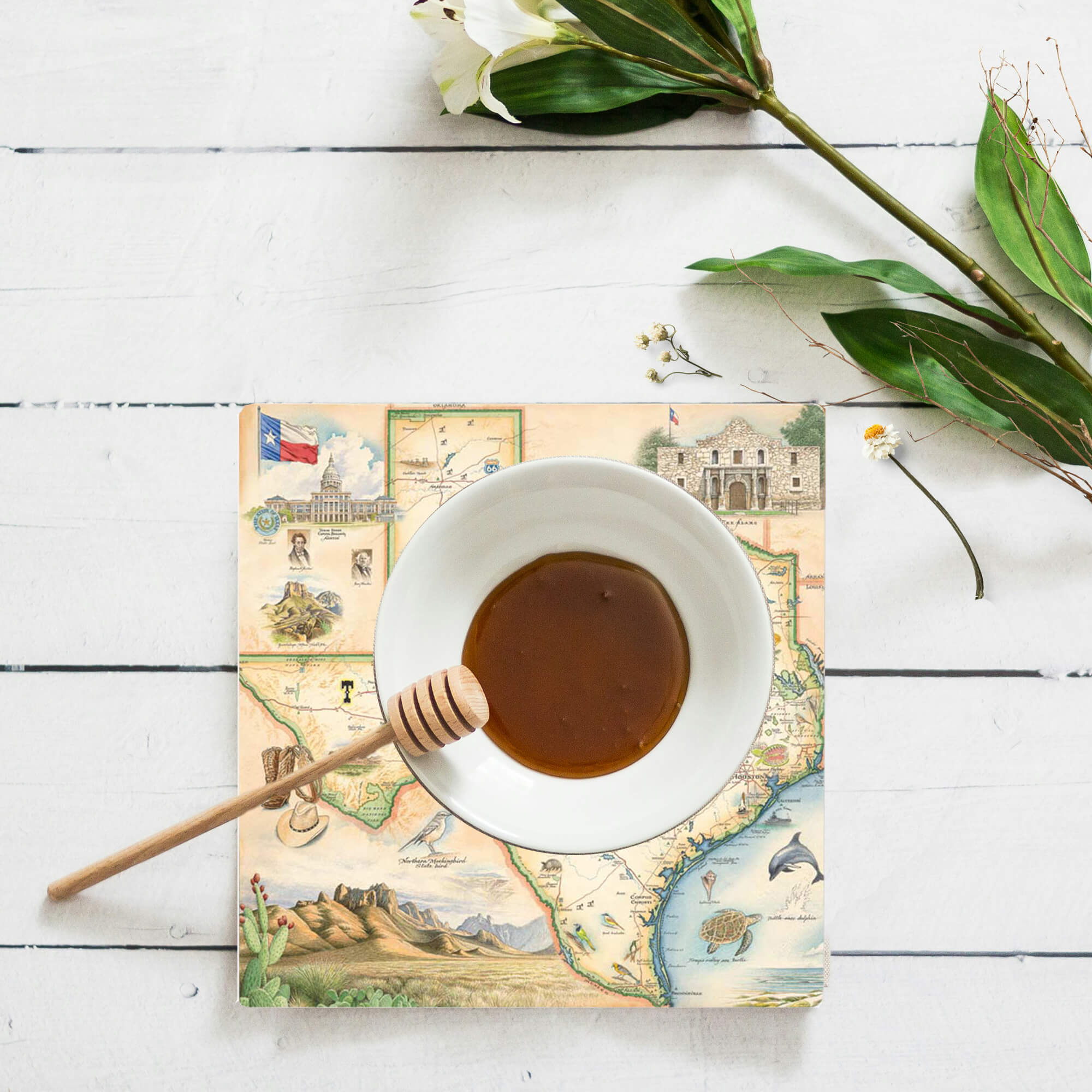 Texas coaster with a saucer of honey dipper stick.