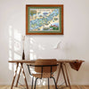 1000 Islands framed hand-drawn map with green mat hanging over a wooden desk and chair.