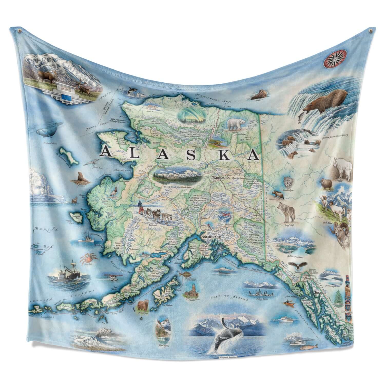 Hanging Alaska fleece blanket. The map includes Denali National Park and cities such as Anchorage, Fairbanks, and Juneau. Illustrations of wildlife matching the region: Polar bears, arctic foxes, moose, caribou, Gray wolves, Dall Sheep, wolverines, Canadian Lynx, King Salmon, Halibut, King Crab, horned puffins, harbor seals, Arctic Tern, ptarmigan, walruses, Kodiak bears, musk ox, Bald Eagles, Mountain Goats and more.
