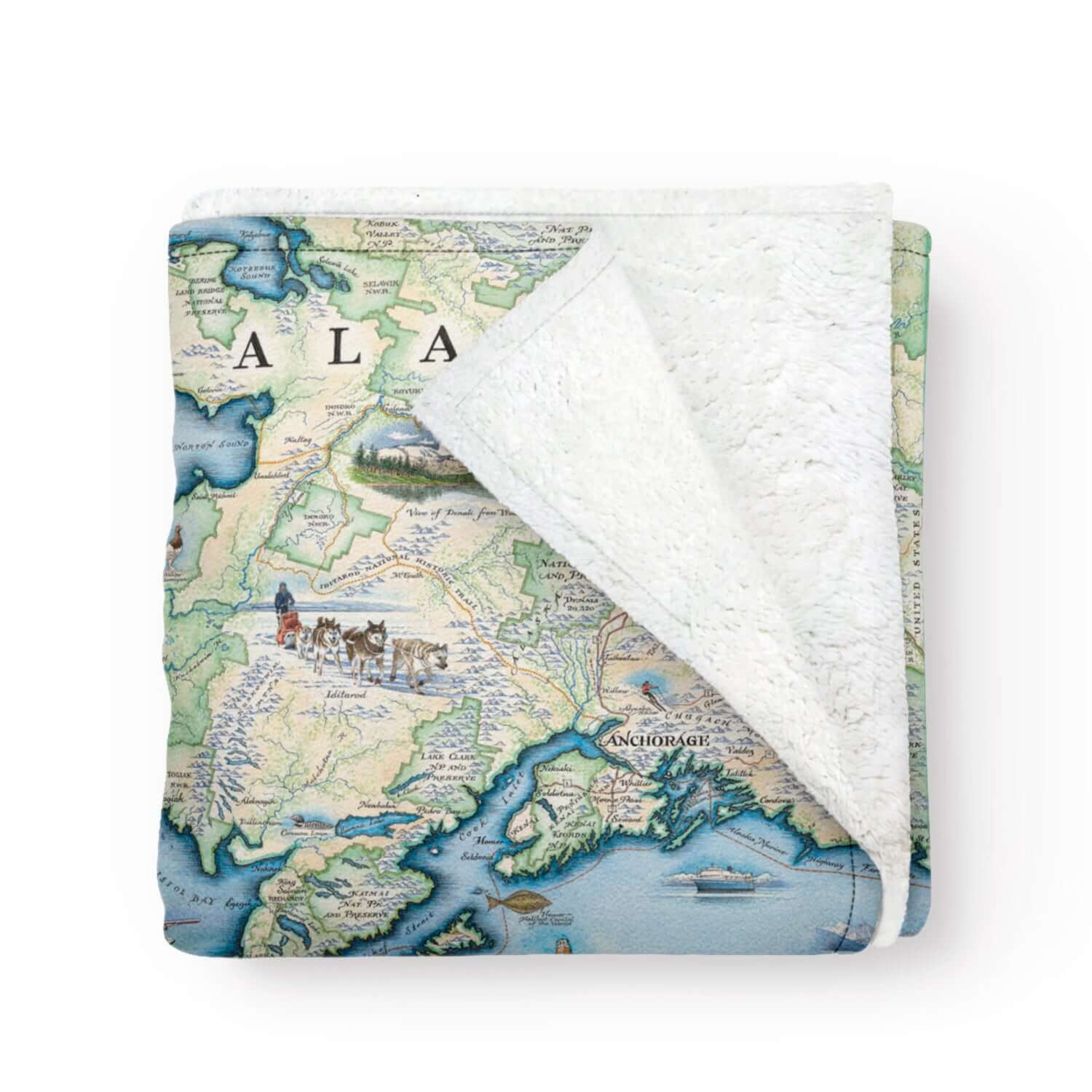 Alaska State map fleece blanket in earth-tone colors. The map includes Denali National Park and cities such as Anchorage, Fairbanks, and Juneau. Illustrations of wildlife matching the region: Polar bears, arctic foxes, moose, caribou, Gray wolves, Dall Sheep, wolverines, Canadian Lynx, King Salmon, Halibut, King Crab, horned puffins, harbor seals, Arctic Tern, ptarmigan, walruses, Kodiak bears, musk ox, Bald Eagles, Mountain Goats and more.
