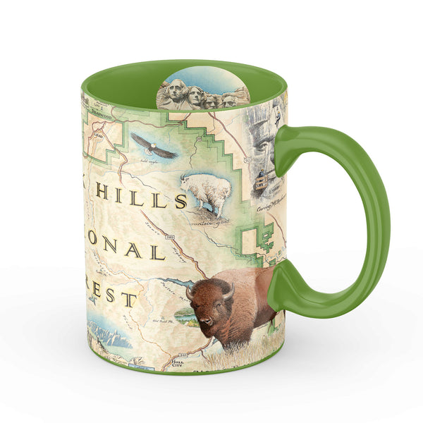 Black Hills National Forest Map Ceramic Mug in green, 16 oz. Features Mount Rushmore, bison, elk, and flowers.