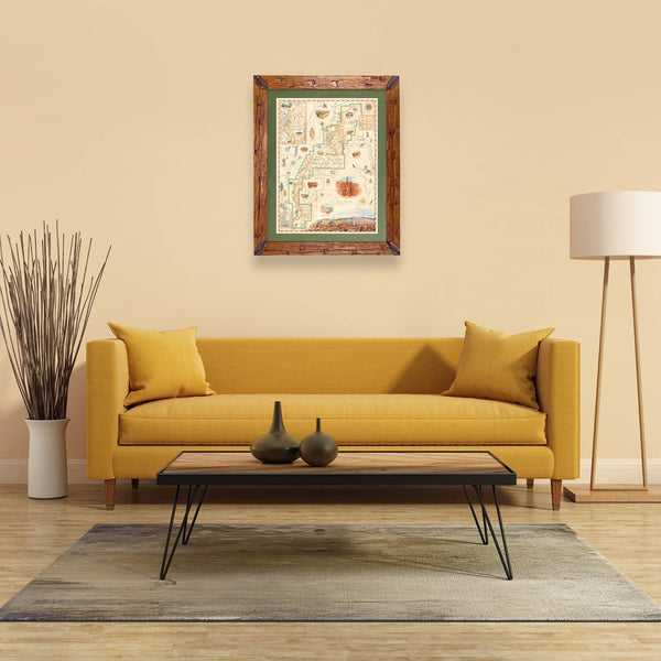 Bryce Canyon National Park Hand-Drawn Map haning on a tan wall over a yellow couch. The map is framed in Montana hand scraped pine with green mat.