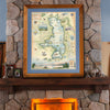 Flathead Lake hand-drawn story-map in a montana larch. The picture is sitting on a mantel ledge on a fireplace.