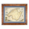 Mallorca Island hand-drawn map in earth tones blues and greens. The map print is framed in Montana hand-scraped pine with a blue mat.