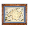 Mallorca Island hand-drawn map in earth tones blues and greens. The map print is framed in Montana hand-scraped pine with a blue mat.