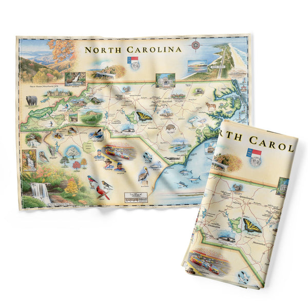 North Carolina state map kitchen dishtowels in earth tone colors of blues and greens. Featuring Dry Falls in the Nantahala National Forest, the Outer Banks, a Nascar Hall of Fame, and the USS North Carolina on the coast.