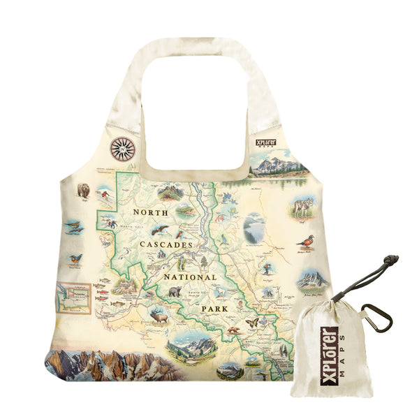 North Cascades National Park Pouch Tote Bags -  Xplorer Maps. The map features illustrations of flora and fauna such as black bears, elk, wolverine, glacier lilies, and huckleberries. Other illustrations include Pickett Range, Cascade Pass, and Lake Chelan Recreation area.