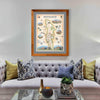 Red Rock Canyon National Recreation Area hand-drawn map in a Montana Flathead Lake Larch frame and gray-purple mat. The print hangs over a purple couch with blue and lime green pillows.