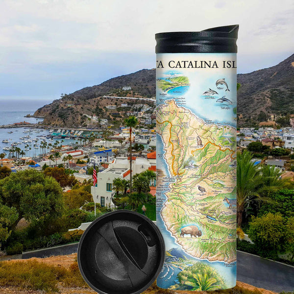 Santa Catalina Island Travel thermos mug with city and mountains in the background. The map features illustrations of places such as Wrigley Memorial, El Rancho Escondido, and Avalon Bay. Flora and fauna include Bison, Catalina Island Fox, Catalina Orange Lip butterfly, Channel Islands tree poppy, and Island oak.