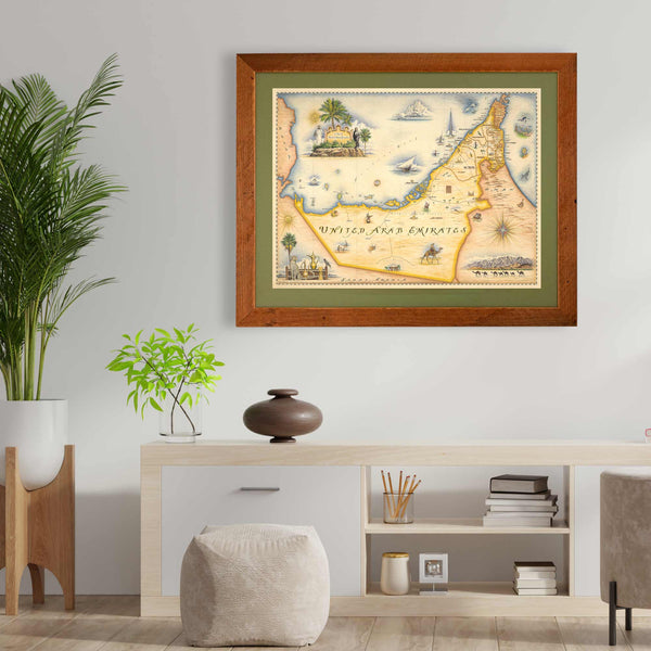 The United Arab Emirates framed hanging on a wall in the living room. There is a plant next to the map print.