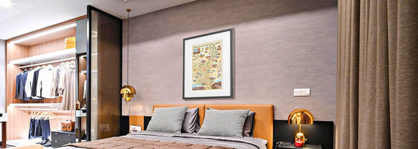 Lithographic map art print features a hand-illustrated map of Arches & Canyonlands National Park. Original hand-drawn pen and ink/watercolor artwork by Chris Robitaille of Xplorer Maps. The Map is hanging over a bed in a bedroom. 