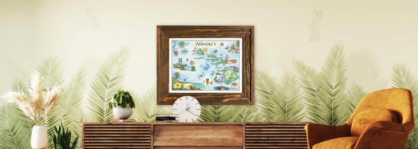 Beautiful map of Hawai’i in a wood frame. The hand-drawn map is hanging above a wooden table and palm leaves wall paper.