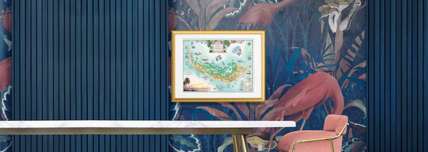 Interior of a Florida home with a pink chair and tropical flamingo wallpaper displaying the Sanibel & Captiva Islands framed map art by Chris Robitaille.