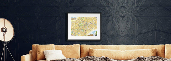 London Collection by Xplorer Maps. The image has a framed map of London hanging on a dark wall above a tan couch. 