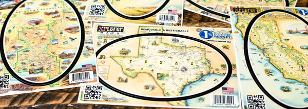 Xplorer Maps sticker collection with Texas, California, Arches & Canyonlands on a wood table. 