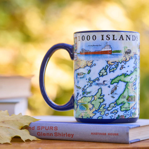 Mug with a map design of the 1000 Islands on top of a book