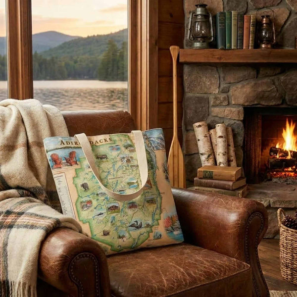 Adirondacks bag on a brown leather chair in a cabin like setting. 