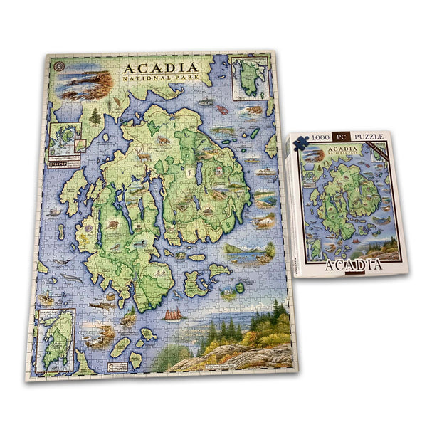 A completed jigsaw puzzle showing a vintage map of Acadia National Park, displayed next to its white box packaging on a clean white background.