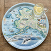 Serving Tray Map of Alaska on a decorative tray with a glass of lemon water.