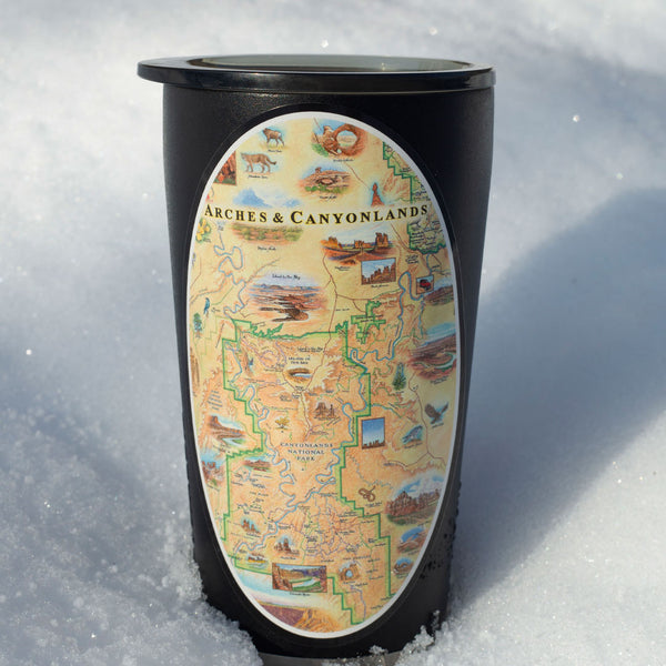 Utah's Arches & Canyonlands National Park sticker on a thermos sitting outside in the snow. 