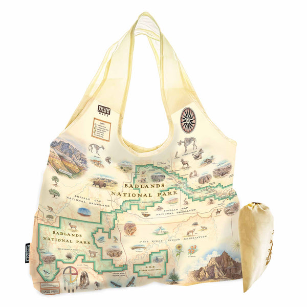 Badlands National Park map nylon stuffable pouch tote bag in earth tone colors.  Featuring Buffalo Gap Grasslands, Vulture Peak, and Yellow Mounds Overlook. Flora and fauna of Jasper Tree, Yucca plant, deer, dinosaurs, birds, and fox.