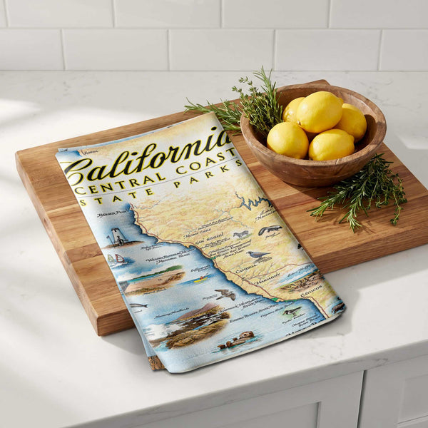 Wooden cutting board with a map of California Central Coast State Park on a kitchen counter.
