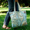 Chesapeake Bay canvas tote bag carried a person in a park like setting.