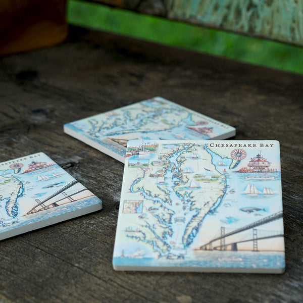 Three Chesapeake Bay map ceramic coasters  sitting on a wooden bench. 