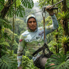 Person on a zip line in a Costa Rican rainforest wearing a hoodie with a map design.