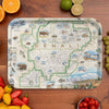 Map of Denali National Park and Preserve on a wooden cutting board with fruits and vegetables around.