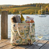Finger Lakes themed tote bag with wine, apples, and a glass of wine on a dock by a lake.
