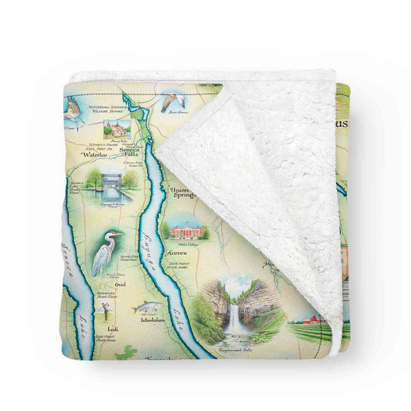  The Folded Finger Lakes Fleece Blanket showcases the stunning beauty of New York State's Finger Lakes region, including Canandaigua, Keuka, Seneca, Cayuga, and Skaneateles Lakes. Seneca is the largest, while Keuka has a distinctive Y-shape. Charming towns like Skaneateles and wine trails around Seneca and Cayuga Lakes add to the region's allure.