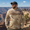 Man wearing a Grand Canyon National Park sweatshirt at the Grand Canyon with scenic view.