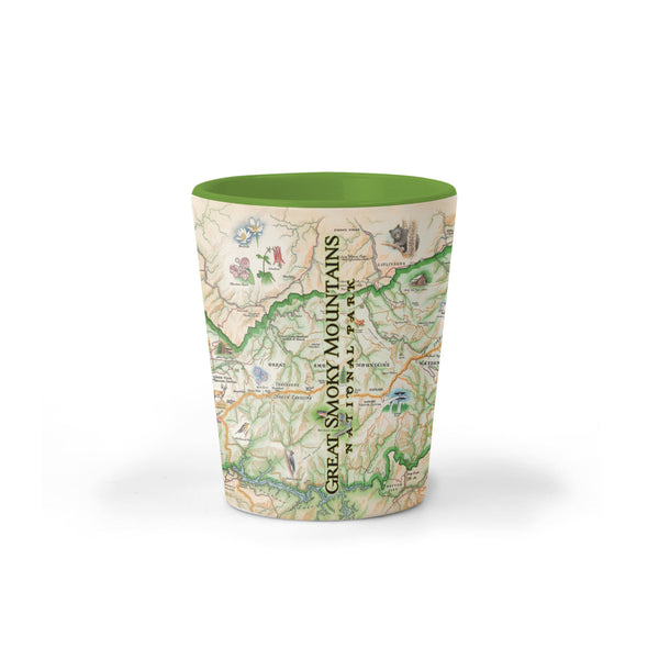 Great Smoky Mountains National Park Map Ceramic shot glass by Xplorer Maps. The map depicts the entire National Park on the border of North Carolina and Tennessee. It features illustrations of a salamander, woodpecker, Clingman's Dome, Sugarland's Visitor Center, and Oconoluftee Visitor Center. 