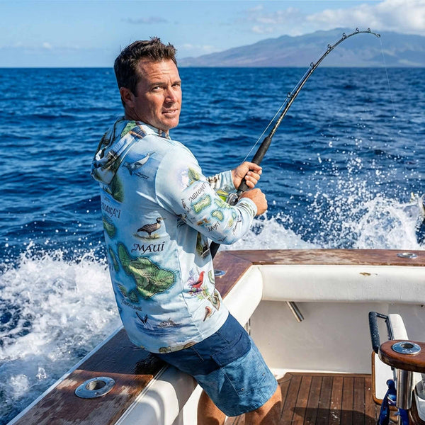 Man fishing on a boat in the Hawaiian Pacific Ocean with a scenic background