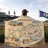 Person holding a Kentucky-themed blanket with a race track in the background