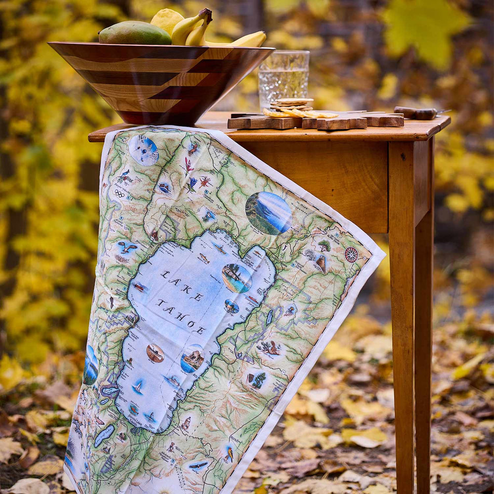 Map of Lake Tahoe on a table with autumn leaves in the background