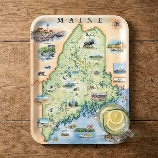 Map of Maine on a decorative tray with a glass of lemonade on a wooden surface