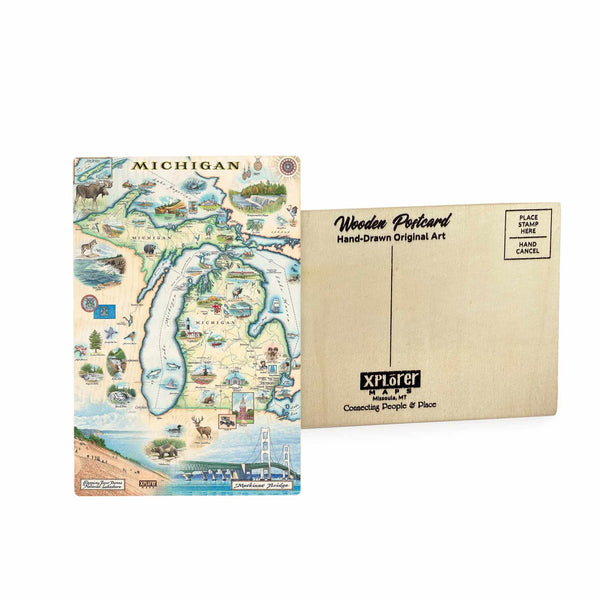 Michigan State Map wooden postcard in earth tone colors featuring hand-drawn landmarks including Mackinac Bridge, Detroit skyline, and wildlife like white-tailed deer and loon.