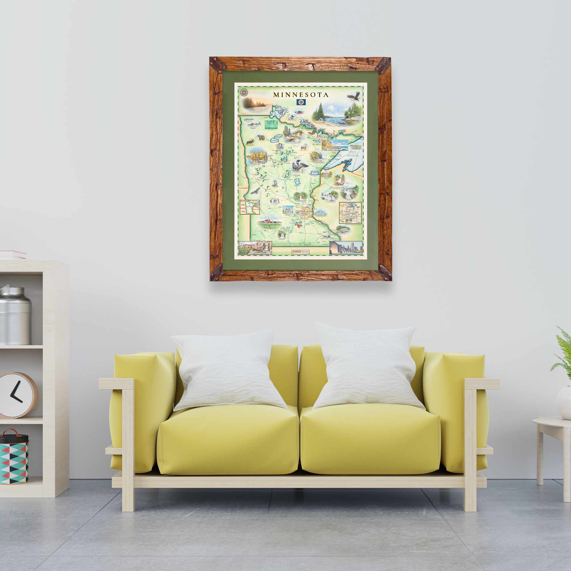 Minnesota State hand-drawn map in earth-tone colors by Xplorer Maps hanging on a wall above a yellow couch. The print is framed in pine with a green frame. 