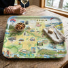 Missoula Map-themed tray on a wooden table with a glass of wine and a bowl of nuts.