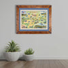 Missoula map print hanging on a gray wall with two potted cacti beneath."