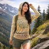 Woman wearing a map-themed hoodie in a mountainous outdoor setting