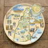 Serving Tray Map of New Hampshire on a decorative plate with a glass of water and lemon.
